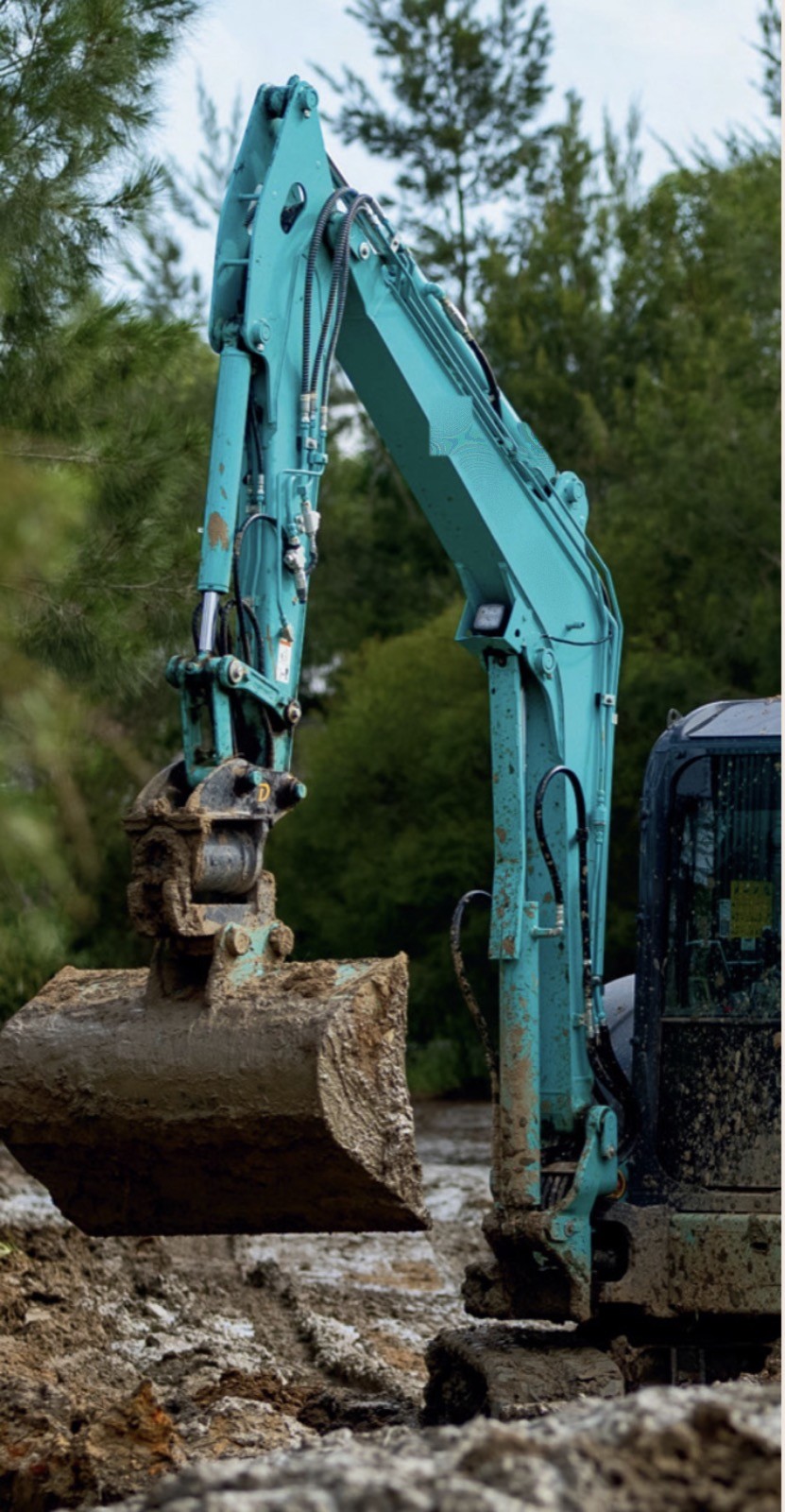 Mud Muscle excavator bucket digging through mud