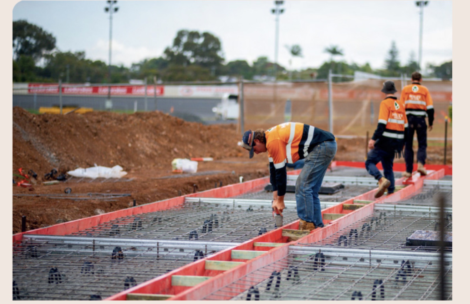 Crew preparing reinforced concrete formwork on a building site
